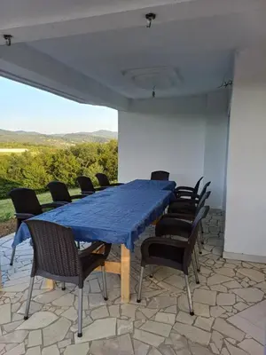 a blue table and chairs on a patio at Vikendica Hangover in Gradačac