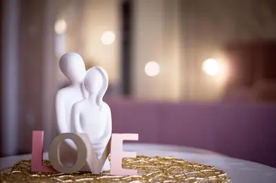a cake with a love figurine on top of it at Royal Imperial in Doboj