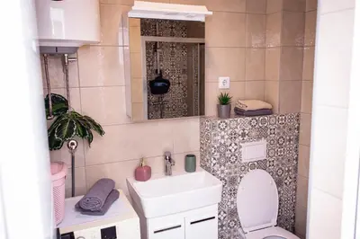 a bathroom with a toilet and a sink and a mirror at Royal Imperial in Doboj