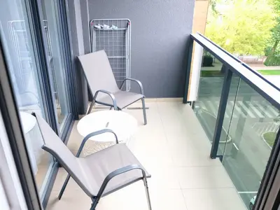 a balcony with two chairs and a table at Cozy Home II in Banja Luka