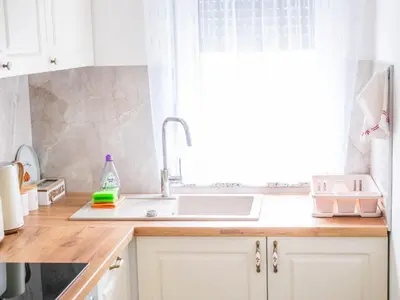a kitchen counter with a sink and a window at Cozy Home II in Banja Luka