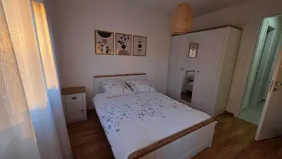 a small bedroom with a bed in a room at Cozy Home II in Banja Luka