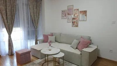 a living room with a couch and a table at Cozy Home II in Banja Luka