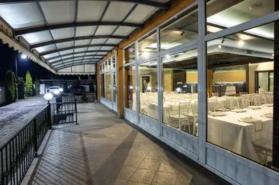 a restaurant with white tables in a building at Motel Calypso Travnik in Travnik