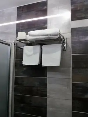 a towel rack with towels on it in a bathroom at Motel Calypso Travnik in Travnik