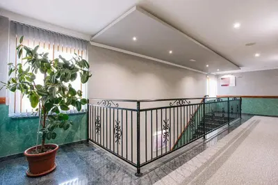 a hallway with a potted plant in a building at Motel Calypso Travnik in Travnik