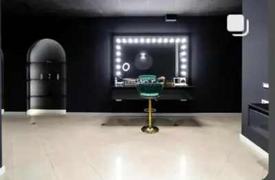 a black room with a green chair in front of a window at Motel Calypso Travnik in Travnik