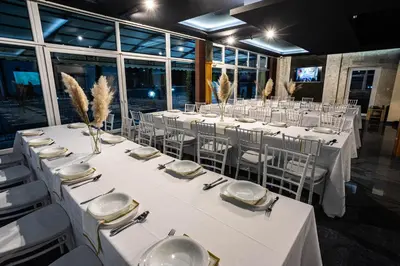 a room with tables and chairs with white tablecloths at Motel Calypso Travnik in Travnik