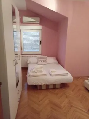 a small room with two beds and a window at Villa S&M in Ivišovo Greblje