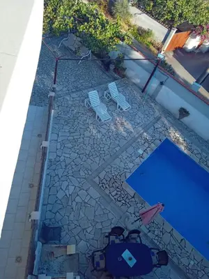 an overhead view of a swimming pool with two chairs at Villa S&M in Ivišovo Greblje