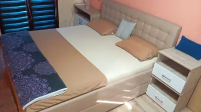 a bed in a small room with a large white bed at PANONSKA JEZERA Zelena Oaza in Tuzla