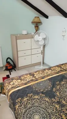 a bedroom with a bed and a dresser with a lamp at PANONSKA JEZERA Zelena Oaza in Tuzla