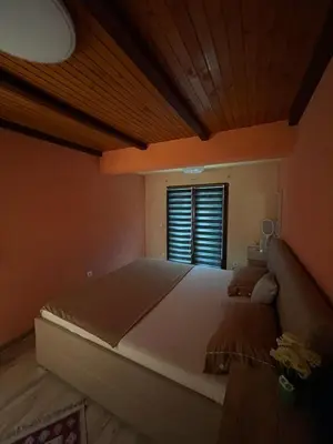 a large bed in a room with a window at PANONSKA JEZERA Zelena Oaza in Tuzla