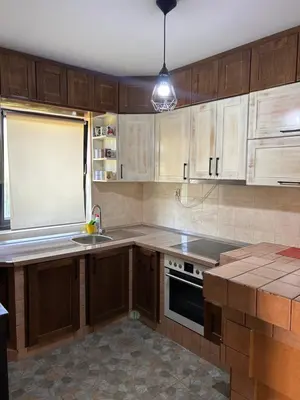 a kitchen with wooden cabinets and a sink at Sofkin salas in Prijedor