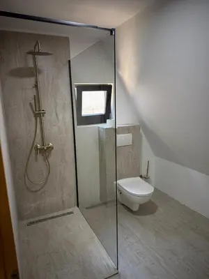 a bathroom with a shower and a toilet at Wooden Houses D&D in Jajce