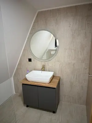 a bathroom with a sink and a mirror at Wooden Houses D&D in Jajce
