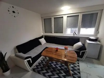 a living room with a couch and a table at Stan na dan - zvijezda Danica Kozarska Dubica in Bosanska Dubica