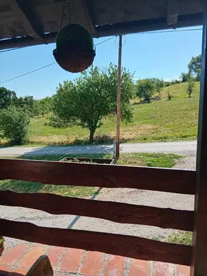 a view of a field from the window of a porch at Vikendica Dion in Srebrenik