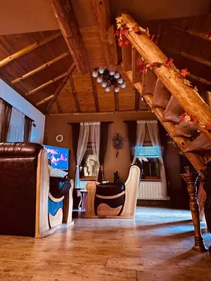 a living room with two chairs and a staircase at Vikendica Dion in Srebrenik