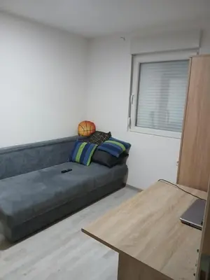 a couch in a living room with a window at Vikendica Lazar in Banja Luka