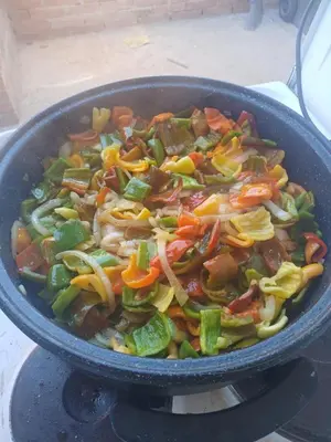 a pan filled with vegetables on top of a stove at Vikendica Lazar in Banja Luka