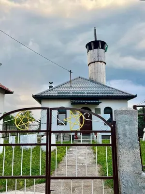 a building with a lighthouse behind a gate at Travnik Nature in Travnik