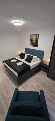 a bedroom with a bed and a couch at SkyDeck8 in Cazin