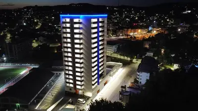 a tall building with a blue light on top of it at SkyDeck8 in Cazin