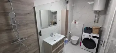 a bathroom with a shower and a sink and a toilet at SkyDeck8 in Cazin