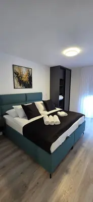 a bedroom with a large bed with pillows on it at SkyDeck8 in Cazin