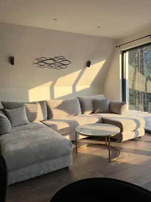a living room with a couch and a table at La Casa Cottage in Jajce