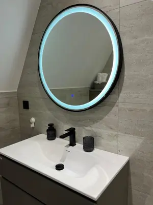 a bathroom with a sink and a mirror at La Casa Cottage in Jajce