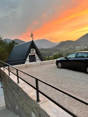 a car parked in front of a church with a sunset at La Casa Cottage in Jajce