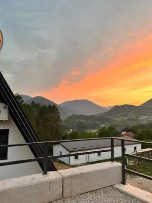 a view from the balcony of a house at sunset at La Casa Cottage in Jajce