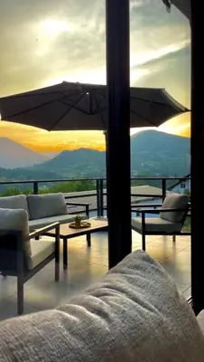 a living room with a couch and an umbrella at La Casa Cottage in Jajce