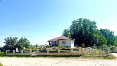 a house behind a fence in front of a house at Hilltop Family House Panoramic Views in Dobrnja