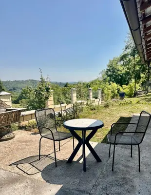 a table and two chairs and a table and a table and chairs at Hilltop Family House Panoramic Views in Dobrnja
