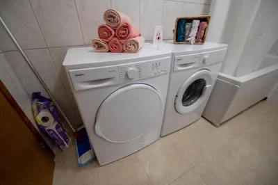 a washing machine with towels on top of it at Apartman Magija in Banja Luka