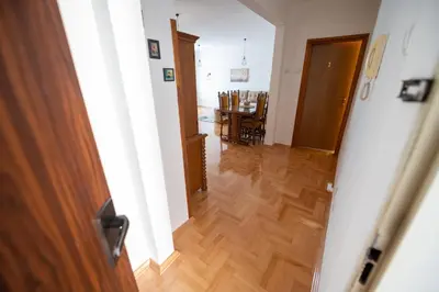an open door to a hallway with a wooden floor at Apartman Magija in Banja Luka