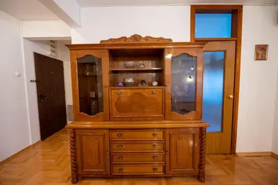 a large wooden cabinet in a living room at Apartman Magija in Banja Luka