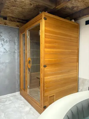 a wooden shower with a glass door in a room at Lux Escape Pridolci in Kozica