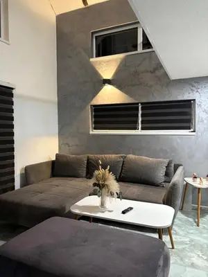 a living room with a couch and a table at Lux Escape Pridolci in Kozica