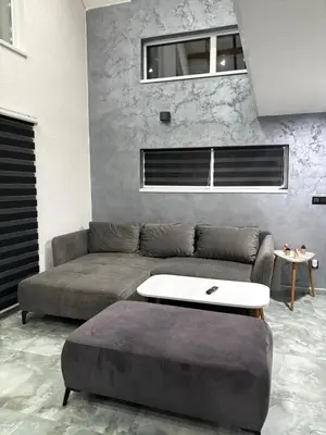 a living room with a couch and a table at Lux Escape Pridolci in Kozica