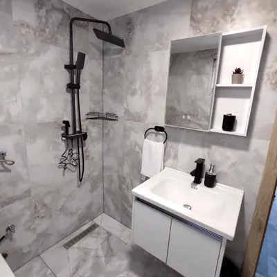 a bathroom with a sink and a shower at Lux Escape Pridolci in Kozica