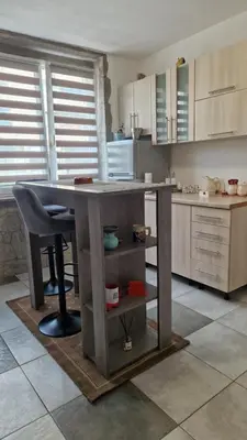 a kitchen with a table and a counter in it at Apartman Katja Travnik in Travnik