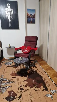 a living room with a chair and a table at Apartman Katja Travnik in Travnik