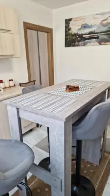 a dining table with two chairs and a table with at Apartman Katja Travnik in Travnik