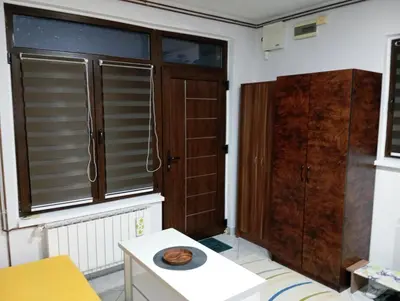 a room with a door and a window and a table at Tuzla Stay Apartment in Tuzla