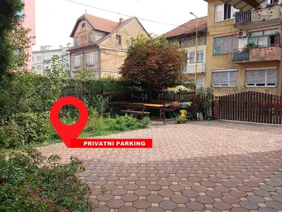 a red sign that says punish parking in a yard at Tuzla Stay Apartment in Tuzla