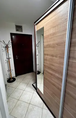 a wooden door with a mirror in a room at Nataša in Doboj
